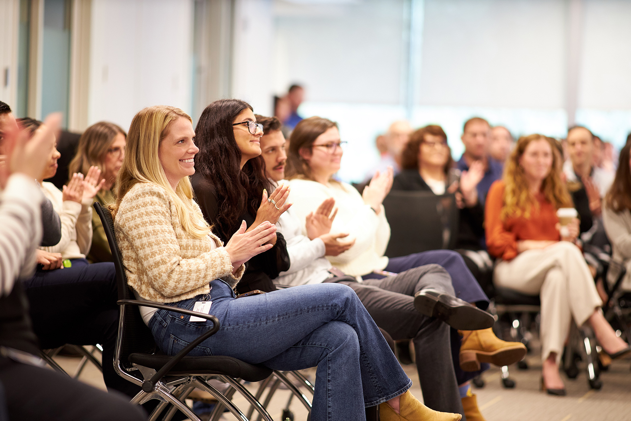 attendees applauding at conference