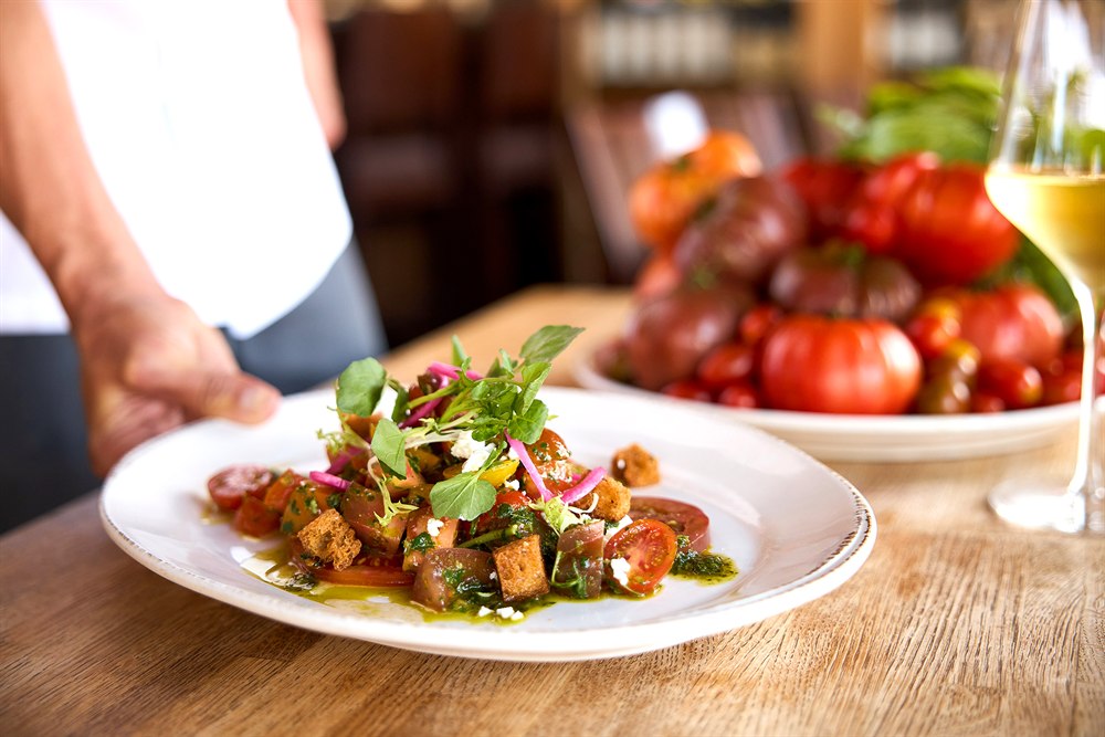Chef presenting an heirloom tomato salad, San Diego restaurant photography