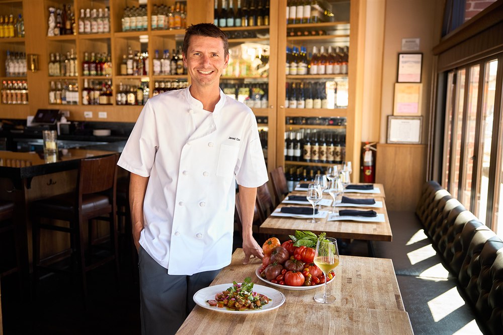 Chef Jared Cook with a platter of heirloom tomatoes at Bloom, San Diego restaurant and chef photography by Rob Andrew