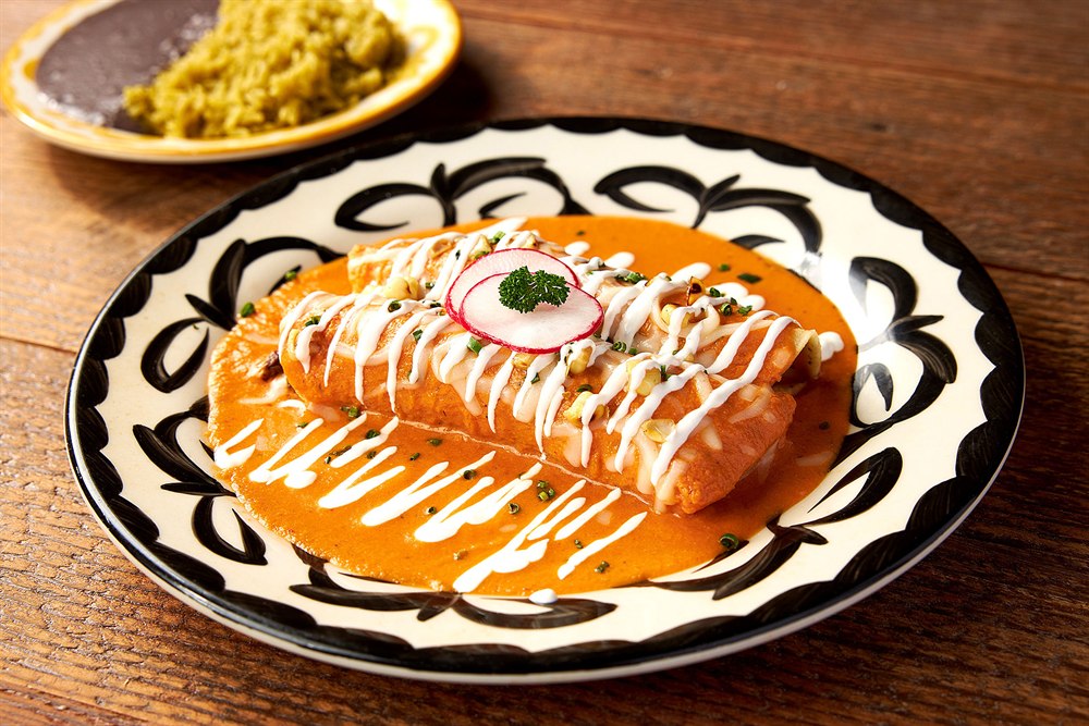 Enchiladas with crema and radish on a patterned plate, San Diego restaurant food photography