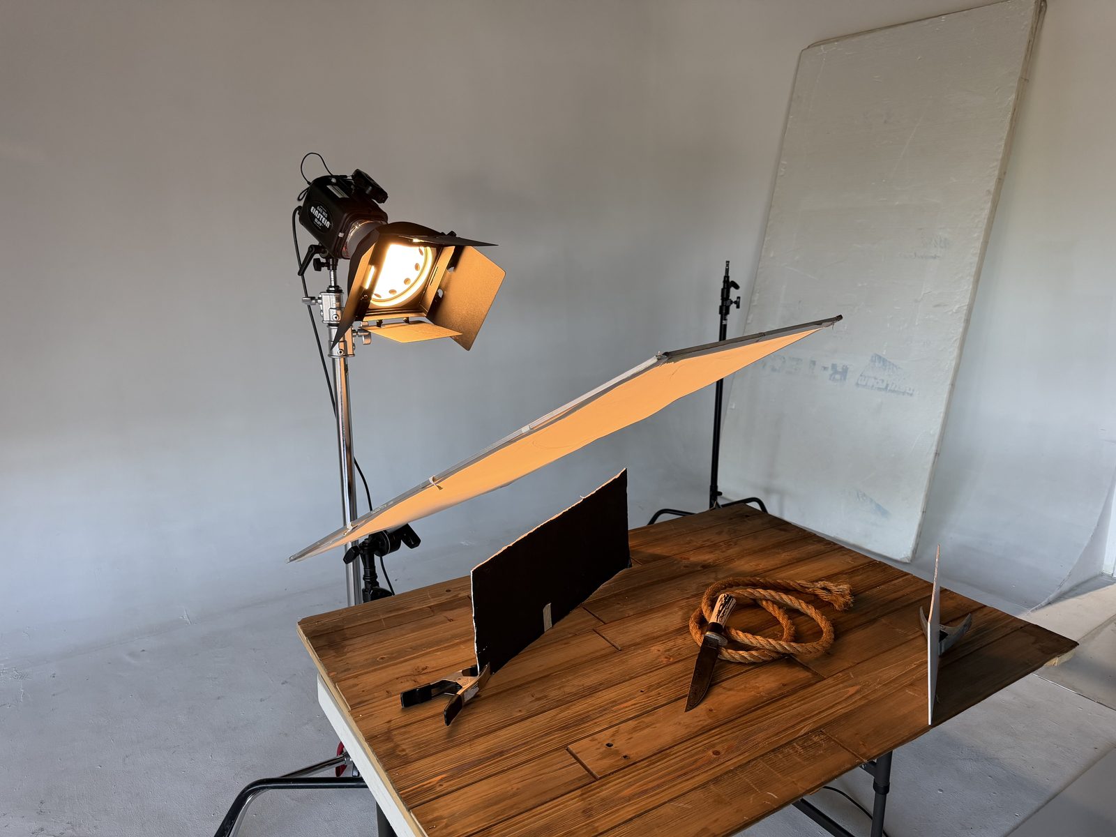 Single light knife photography setup with diffusion screen and barn doors in a San Diego studio