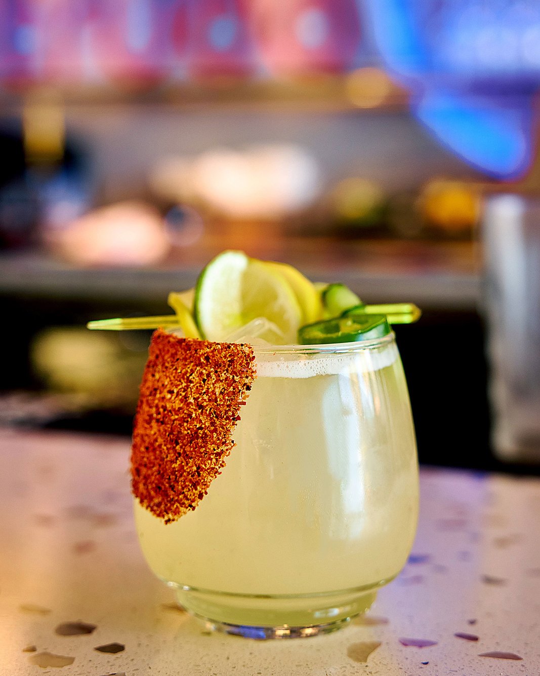 Cocktail with a chili salt rim and jalapeno at the bar, San Diego beverage photography